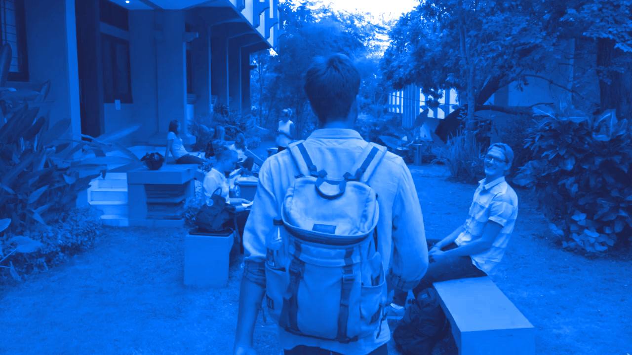 Student with a backpack arriving on the university campus in Bali